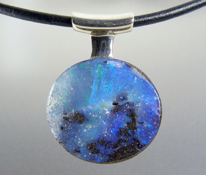 Boulder opal pendant in silver - Boulder opal pendant in silver on leather thong. Pendant 21x27mm.