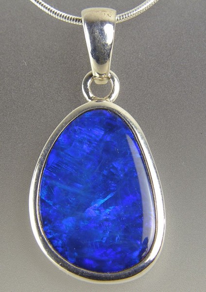 Boulder opal pendant in silver - Opal doublet pendant in silver on silver chain. Pendant 14x30mm.
