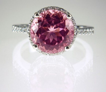 Pink tourmaline & diamond ring - Blush pink tourmaline from Nuristan, 10mm in diameter, 4.3ct weight ,in 18ct white gold surrounded by 0.3ct white diamonds.
