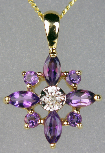 Amethyst & diamond pendant in 9ct yellow & white gold - 0.38ct of amethysts set with 0.004ct diamonds in 9ct yellow & white gold. This is a really pretty star shaped pendant suspended from an 18" 9ct yellow gold chain.