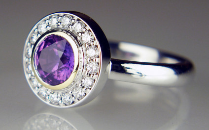 Purple sapphire halo ring - Remodel of client's own sapphire and diamonds. Making a silk purse out of what can only be described as a sow's ear!  Check out the Just Gems Facebook page to see more. We do a fabulous job of remodelling other goldsmith's mistakes.