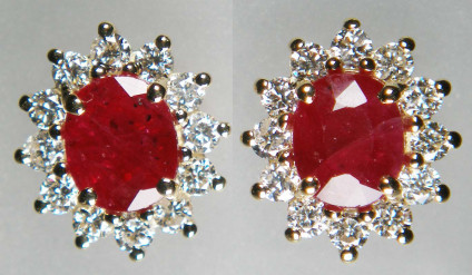 Ruby & diamond cluster earstuds in 9ct yellow gold -  Oval ruby pair - included natural heat treated but NOT glass filled - weighing 1.87ct, claw set and surrounded by 0.54ct of round brilliant cut white diamonds, in 9ct yellow gold earstuds. Earstuds measure 9 x 10mm.