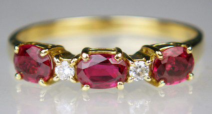 Ruby & diamond ring in 18ct yellow gold - Eternity style ring in 18ct yellow gold set with 0.90ct oval rubies and 0.06ct diamonds. This pre-loved ring has been carefully inspected by our gemmologist and goldsmith and comes with a six month Just Gems warranty.