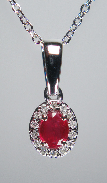 Ruby & diamond pendant in 18ct white gold - 0.23ct oval ruby in a halo of diamonds, total diamond weight 0.06ct, mounted in 18ct white gold. Pendant is 13mm long. The pendant is £325 and the 18ct white gold chain is £120.