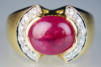 Ruby cabochon & diamond ring in 18ct yellow gold - 5ct ruby cabochon with 0.25ct of round brilliant cut diamonds and set in satin finished and polished 18ct yellow gold. This ring is pre-loved, it has been carefully inspected by our gemmologist and goldsmith and comes with a 6 months Just Gems warranty.