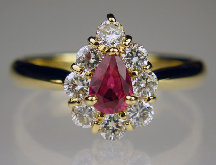Pear cut Ruby & Diamond Ring - Lovely ruby and diamond cluster ring in 18ct yellow gold set with 0.46ct ruby and 0.59ct diamonds in H colour SI clarity. This is a charming piece with the central ruby really clean and lively. One of our favourites!