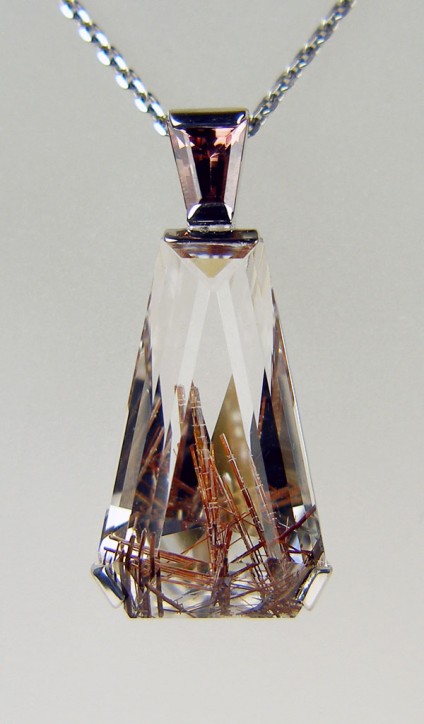 Rutilated quartz and tourmaline pendant in white gold - Delicate pendant in 9ct white gold set with 19.3ct rutilated quartz specially cut by Ivan Williamson of Hascosay Gems, and also set with a small tapered baguette tourmaline.