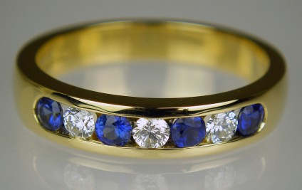 Sapphire & diamond half eternity ring in 18ct yellow gold - 0.37ct sapphires & 0.21ct diamonds set in 18ct yellow gold. Ring size N - this ring cannot be adjusted for size.