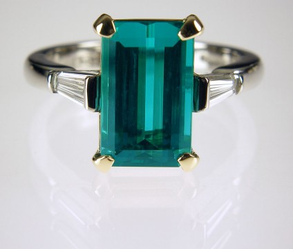 Tourmaline & diamond ring - Sea green Afghan tourmaline 4.5ct set with a matched pair of tapered baguette diamonds G/VS 0.44ct in 18ct yellow gold with a platinum shank. Centre stone 8 x 12mm.
