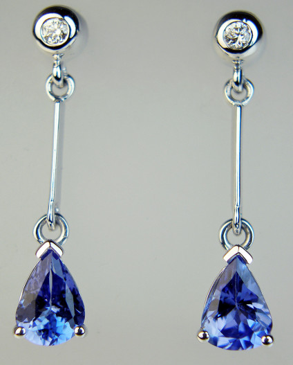 Tanzanite & diamond eardrops in white gold - 1.29ct pair of pear cut tanzanites set with 0.065ct of round brilliant white diamonds in 9ct white gold. Eardrops are 25mm long.