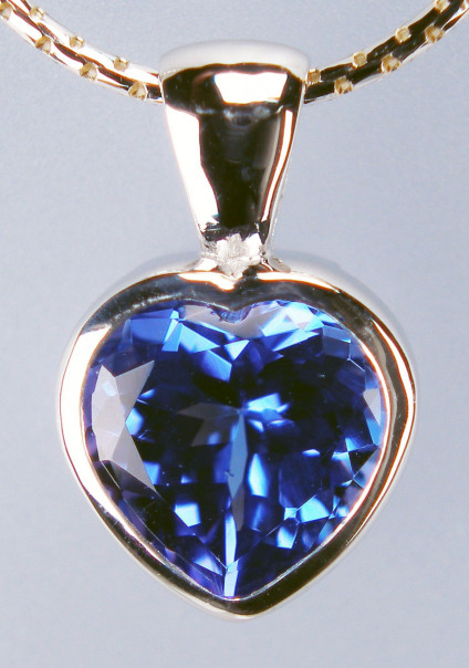 Tanzanite heart pendant in 9ct yellow gold - 8mm tanzanite heart weighing 1.93ct in a rich blue, rubover set in 9ct yellow gold heart pendant and suspended from a 9ct yellow gold anaconda style chain