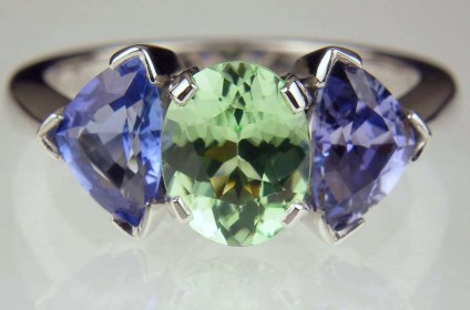 Tourmaline & sapphire ring - 1.26ct pale green tourmaline set with a 1.71ct matched pair of lilac blue sapphires in 18ct white gold