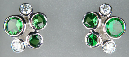 Tsavorite & diamond earstuds in 9ct white gold - Rubover set cluster earstuds of round brilliant cut diamonds and tsavorites, 1.12ct tsavorite garnets & 0.2ct diamonds, all in 9ct white gold. Earstuds measure 9 x 11mm.