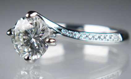 1.31ct diamond solitaire in twist style platinum ring - J colour VS2 clarity round brilliant cut diamond weighing 1.31ct set with 0.07ct small round brilliant cut diamonds in platium ring