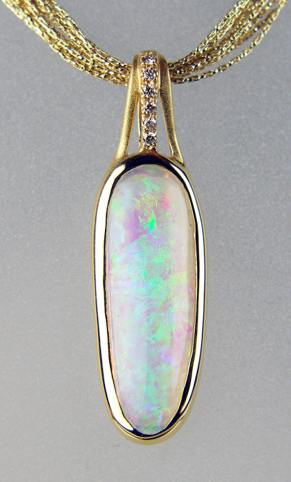 Crystal opal & diamond pendant in 18ct yellow gold - Beautiful Australian cabochon crystal opal weighing 2.5ct and set as a pendant with 0.03ct of I colour SI clarity round brilliant cut diamonds, mounted in 18ct polished and satin finished gold, suspended from a 10 strand 'smell of gold' Beulling 18ct yellow gold chain