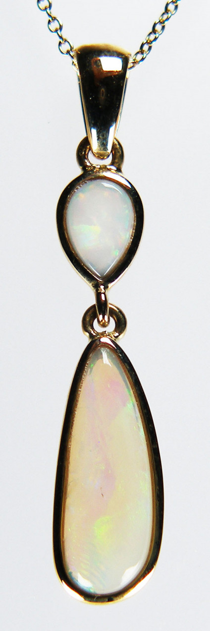 White opal pendant in 9ct yellow gold - Delicate elogated and pear shaped white opal cabochons rubover set in 9ct yellow gold pendant. The pendant is 23mm long. The chain is avaailable for separate purchase.