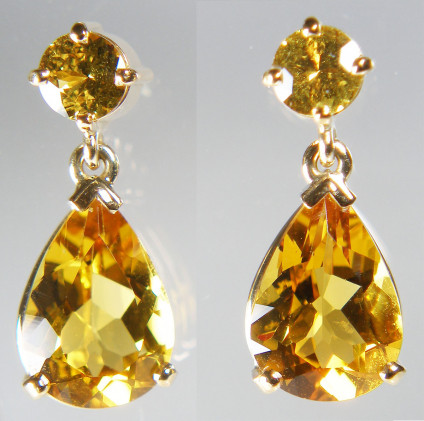 Golden beryl and yellow sapphire earrings in 18ct yellow gold  - The earrings are made up of a 4.09ct pair of pear cut golden beryls (also known as Heliodor), mounted with a pair of round brilliant cut yellow sapphires of 0.75ct.


