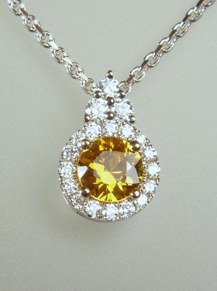 Golden sapphire & diamond pendant - 0.58ct intense golden orange sapphire round brilliant cut set as a pendant with 0.16ct G/VS diamonds in 18ct white gold