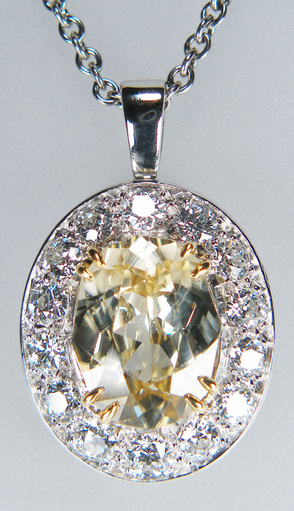 Natural yellow zircon & daimond pendant in platinum - 8.73ct oval yellow zircon, highly dispersive and looking just like a yellow diamond, surrounded by 2.25ct of G colour VS clarity round brilliant cut diamonds, mounted as a pendant in platinum. Pendant is 29 x 19mm. Pendant is suspended from a 20" adjustable to 16" & 18" platinum trace chain. Chain is £960, pendant is £9995